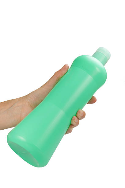istock Female hand is holding a green plastic bottle 479202542