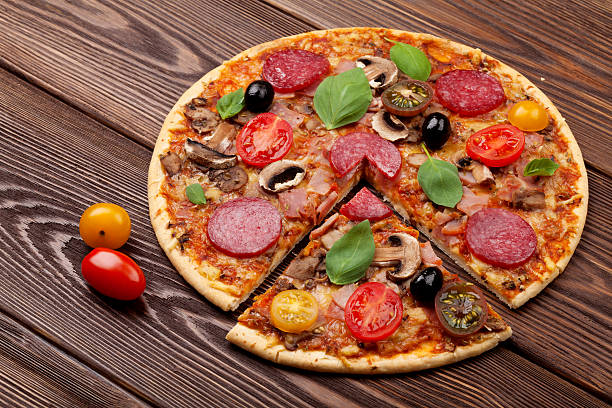 istock Italian pizza with pepperoni, tomatoes, olives and basil 479203606