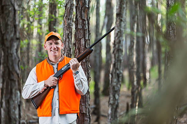 istock Man in woods hunting with shotgun 479203630