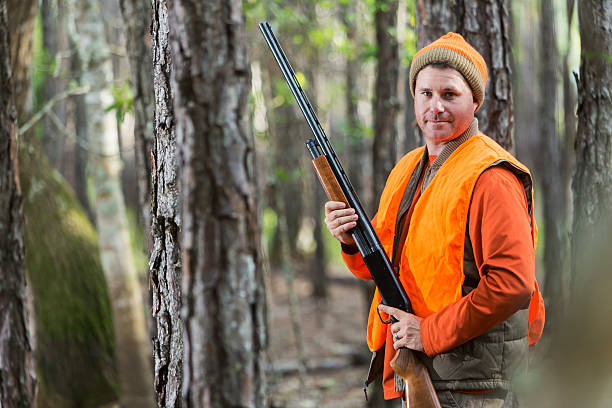 istock Man in woods hunting with shotgun 479203634