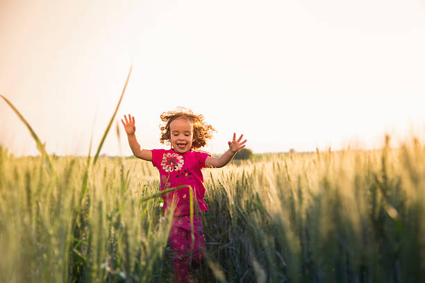 istock Cute little girl running through field 479203684