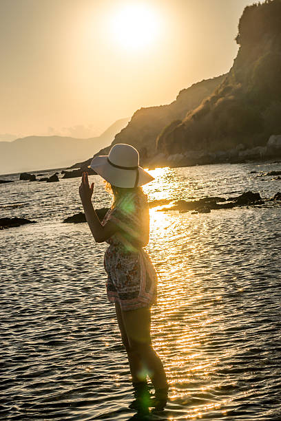 istock Woman with hat looking at sunset 479205225
