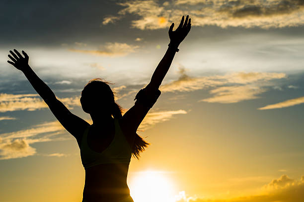 istock strong confidence woman open arms under the sunrise at seaside 479207378