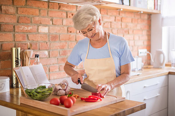 istock Senior woman cutting vegetables 479210064