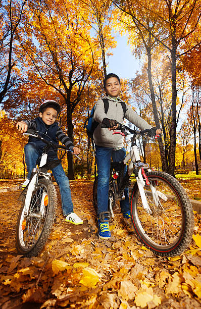 istock Boys rides bicycles in the park 479212567