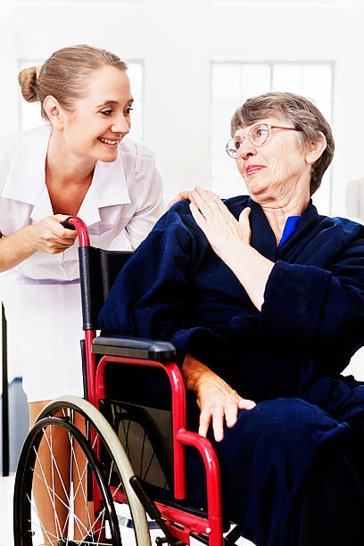 istock Affectionate moment between caring nurse and her aged female patient 479212627