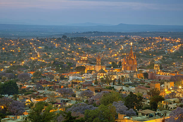 Aerial View of San Miguel de Allende in Mexico Illuminated skyline of San Miguel de Allende in Mexico after sunset. san miguel de cozumel stock pictures, royalty-free photos & images