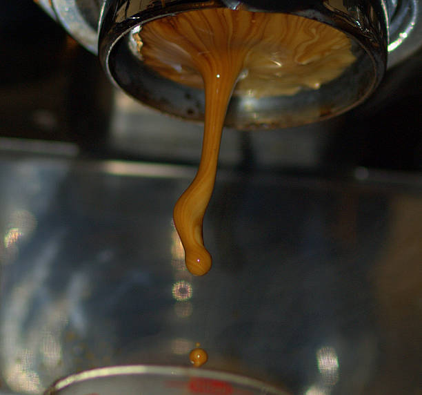 espresso dripping from machine