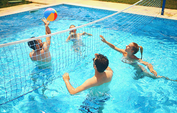 Playing In A Pool Stock Photo - Download Image Now - Swimming Pool, - Sport, Volleyball - Ball - iStock