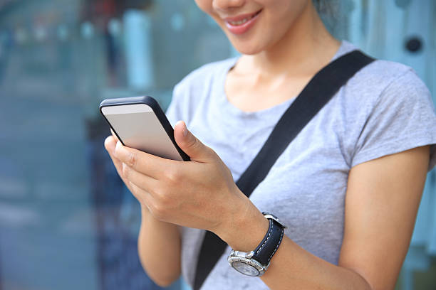 istock young asian woman use smartphone at city 479217040