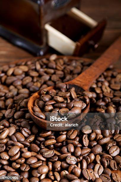 Grinder And Coffee Beans With A Wooden Spoon Stock Photo - Download Image Now - 2015, Brown, Caffeine