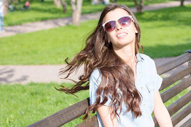 Summer portrait of laughing woman with sunglasses and streaming hair Summer portrait of laughing woman with sunglasses and streaming hair dispelled stock pictures, royalty-free photos & images