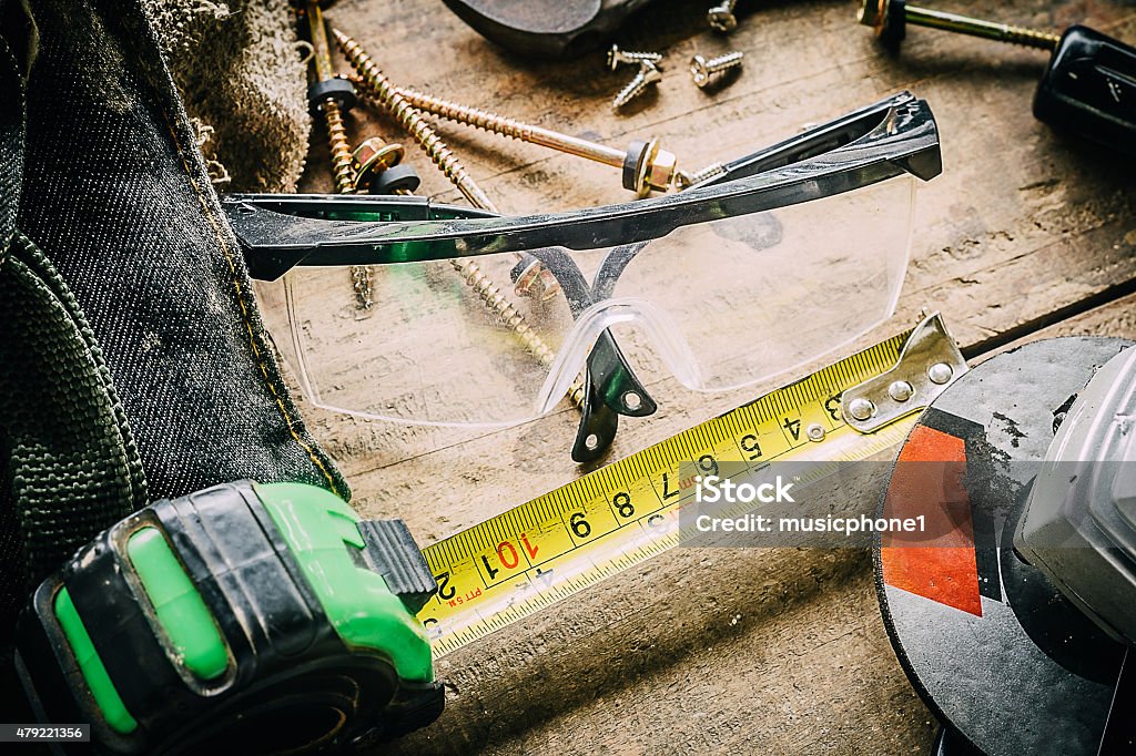 Different tools on a wooden background. Dirty set of hand tools on a wooden panel 2015 Stock Photo