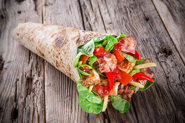istock Chicken slices in a Tortilla Wrap on wood. 479222159