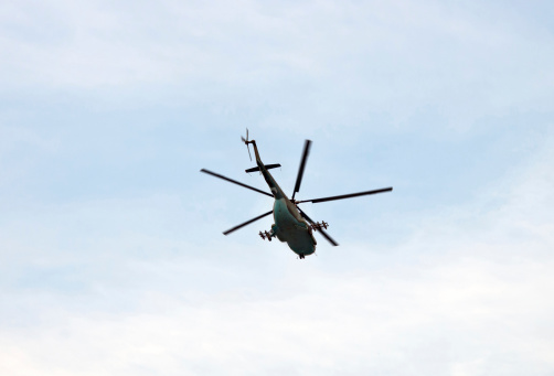 Military helicopter flying above a military base during a mission.