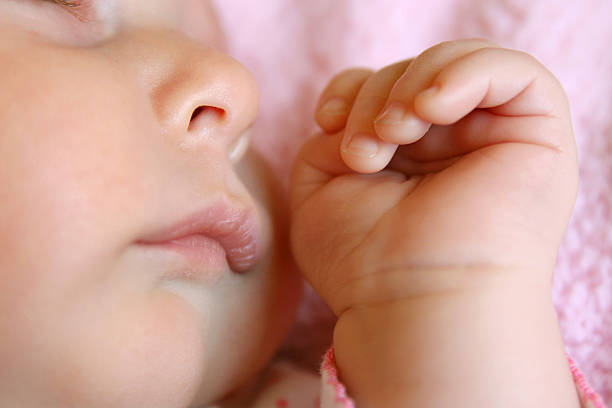 istock Close up on Hands and Face of Sleeping Baby 479225582