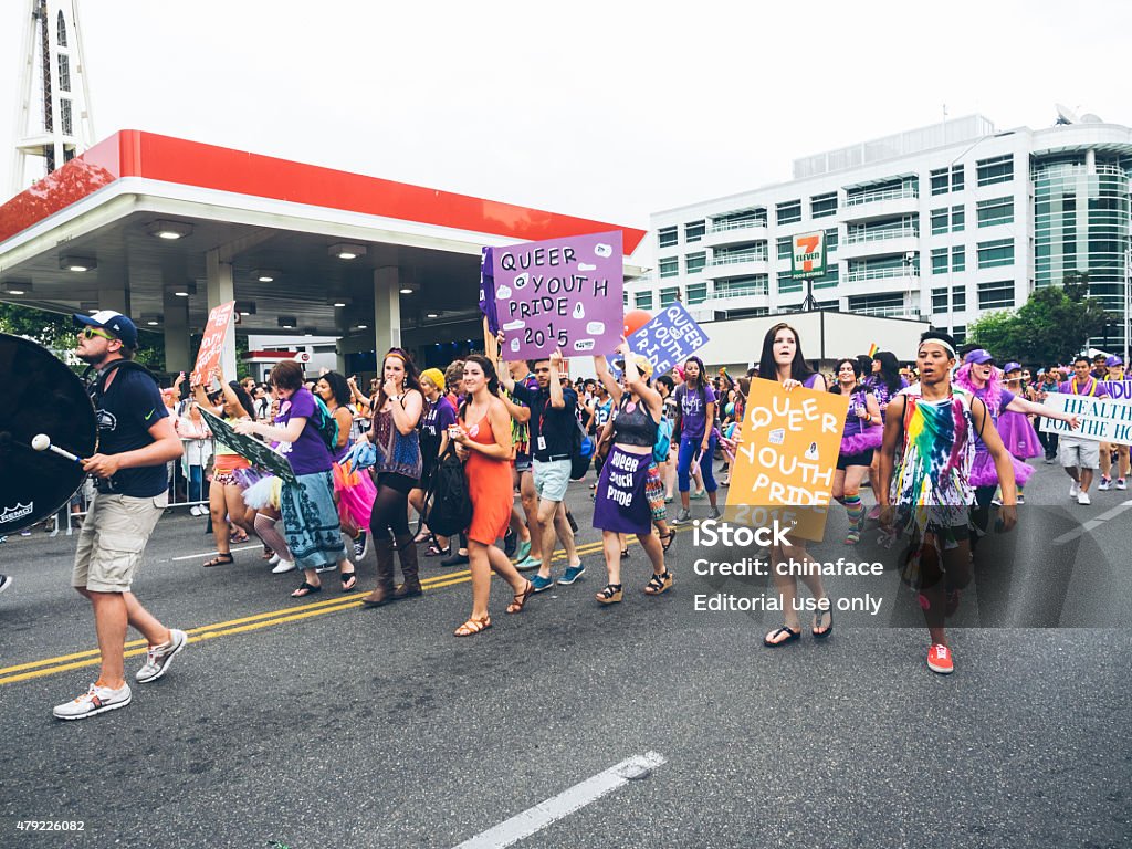 2015 Seattle Pride Parade Seattle, Washington, USA- June 29, 2015: This image shows participants in the 2015 Seattle Pride Parade. The Pride Parade celebrates gay rights and attracts large crowds each year. These people are walking along the parade route. 2015 Stock Photo