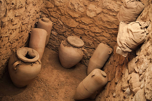 Group of Ancient Roman terracotta amphora containers on display in a ruined house at Pompeii in Italy. They were used for transporting wine, or oils