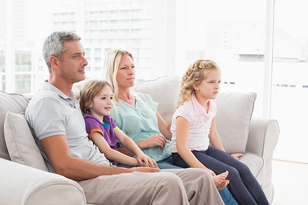 istock Family watching TV while sitting on sofa 479233732