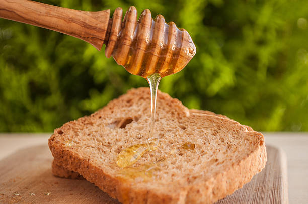 istock toasted bread with honey and honey dipper 479234304