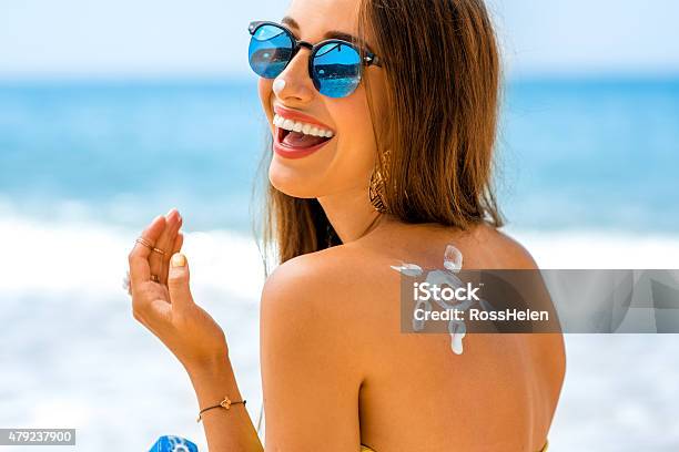 Woman Using Sun Cream On The Beach Stock Photo - Download Image Now - Suntan Lotion, Women, Summer