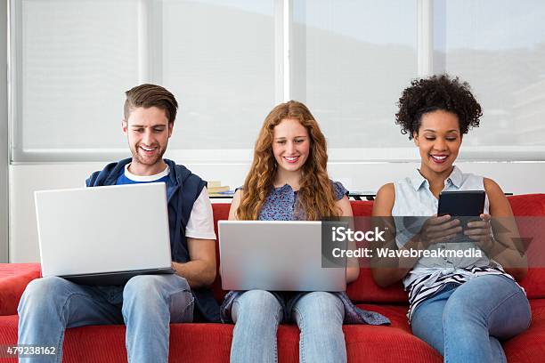 Creative Team Using Laptops And Digital Tablet Stock Photo - Download Image Now - 18-19 Years, 20-24 Years, 20-29 Years