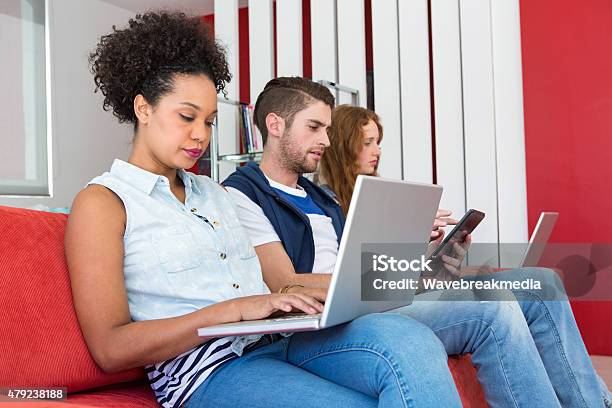 Creative Team Using Laptops And Digital Tablet Stock Photo - Download Image Now - 18-19 Years, 20-24 Years, 20-29 Years