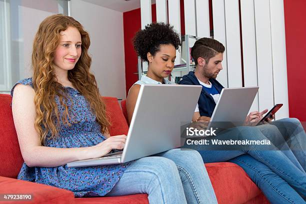 Creative Team Using Laptops And Digital Tablet Stock Photo - Download Image Now - 18-19 Years, 20-24 Years, 20-29 Years