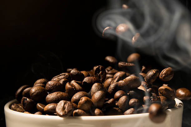 istock Coffee mug full of coffee beans with smoke 479238742