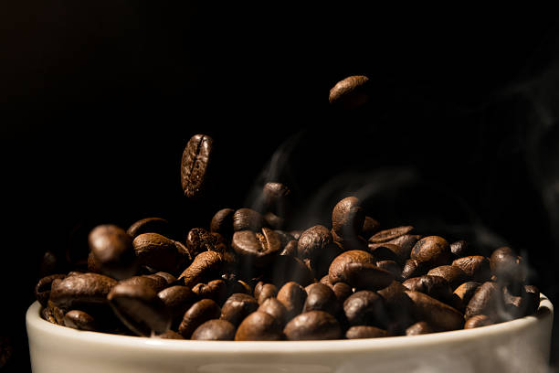 istock Coffee mug full of coffee beans with smoke 479238748