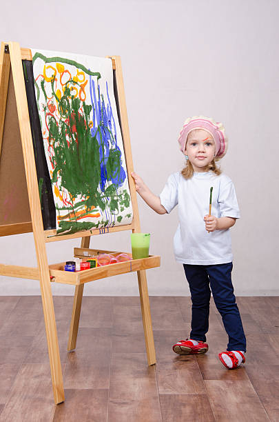 istock Girl artist paints on canvas 479242177