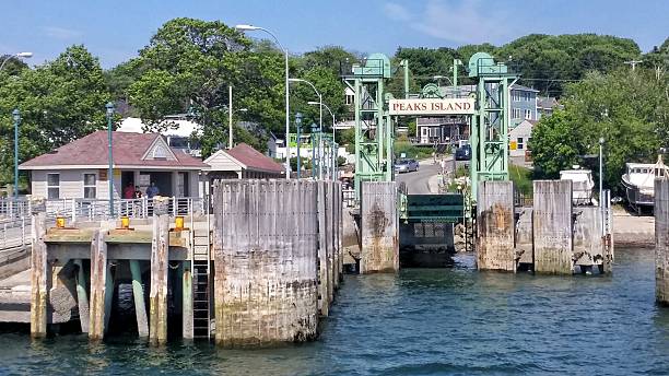 Peaks Island Ferry Terminal Landing, Casco Bay Near Portland, Maine Peaks Island is a small island with a population of less than 1000 residents and about twice as many in the summer time. It is accessible by a 20 minute ferry ride from Portland, Maine. casco bay stock pictures, royalty-free photos & images