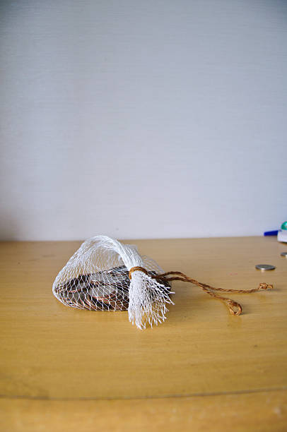 istock Coin in net bag on wood table 479242602
