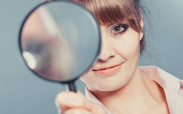 istock Woman holding magnifying glass 479248792