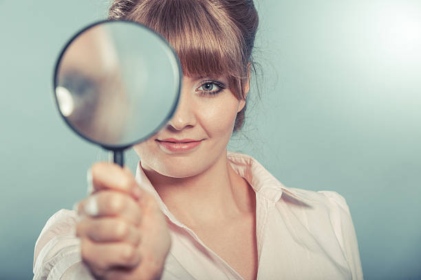 istock Woman holding magnifying glass 479250856