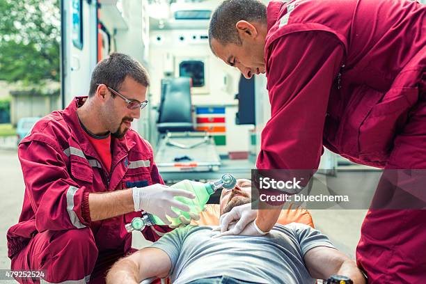 Emergency Service Rescuing An Infarcted Stock Photo - Download Image Now - City, Paramedic, Healthcare And Medicine
