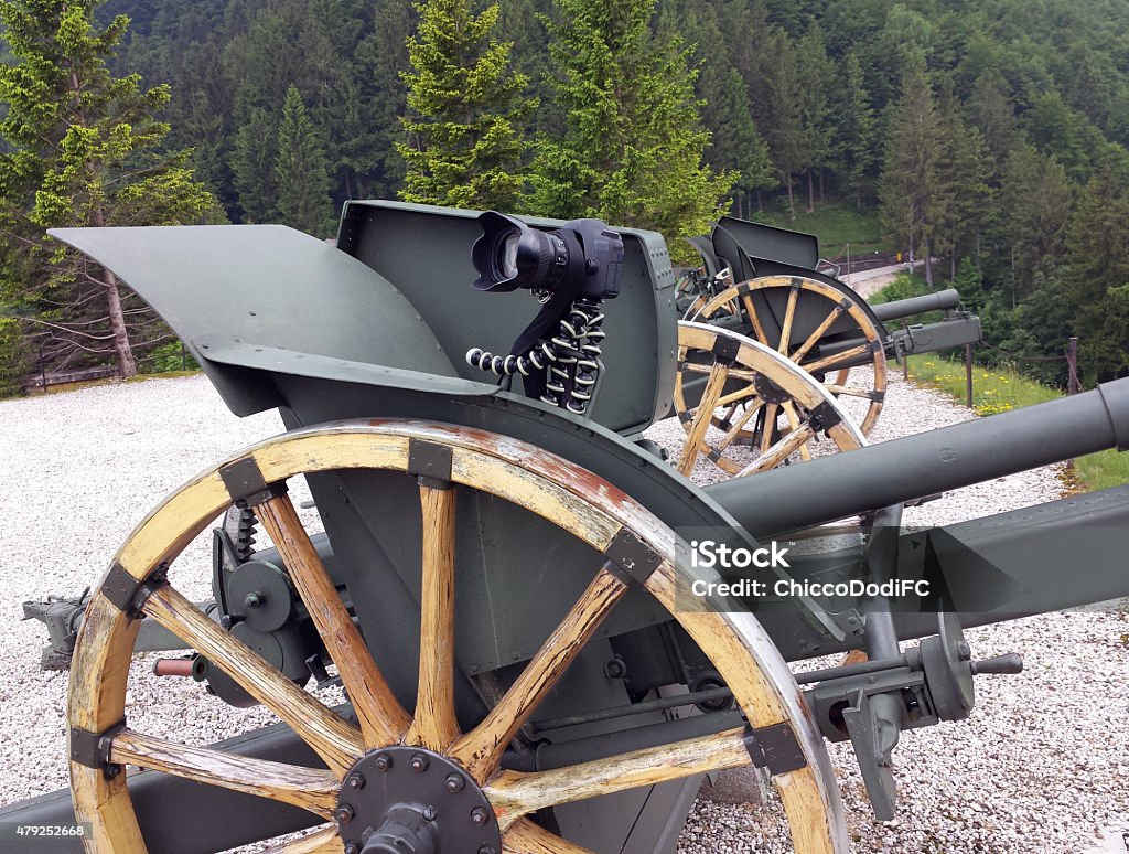 fantastic camera tripod over an old World War I Cannon versatile camera tripod over an old World War I Cannon 2015 Stock Photo