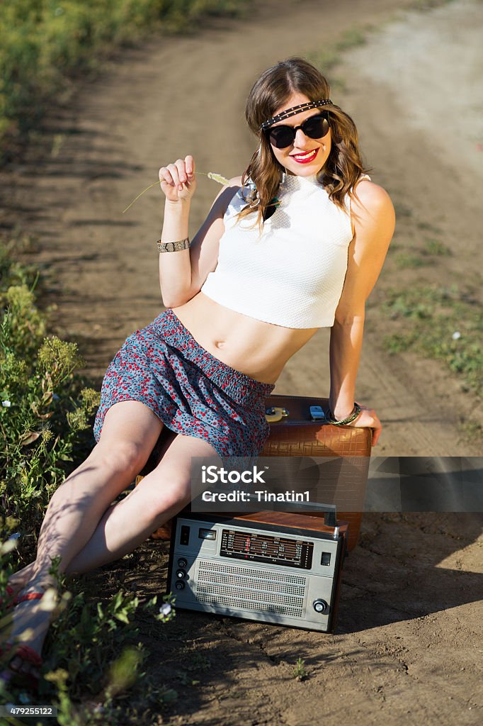 Beautiful girl on a road Beautiful hippie girl alone on the countryside road 1970-1979 Stock Photo