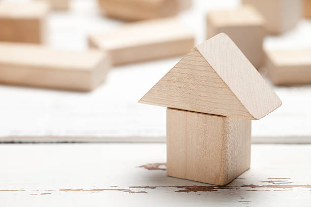 istock Wooden toy house on white table 479255336