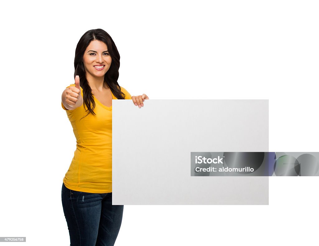 Woman showing placard and thumbs up Woman showing an empty placard and thumbs up sign while smiling isolated over white background 2015 Stock Photo