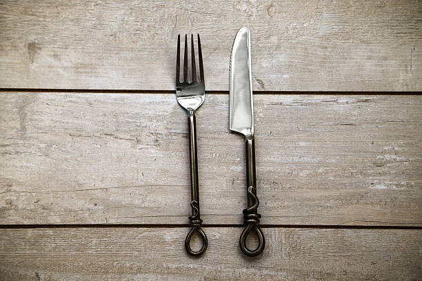 istock Silver Knife and fork over wooden table 479257142
