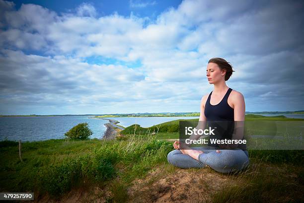 Doing Yoga By The Sea Stock Photo - Download Image Now - 20-29 Years, 2015, Activity