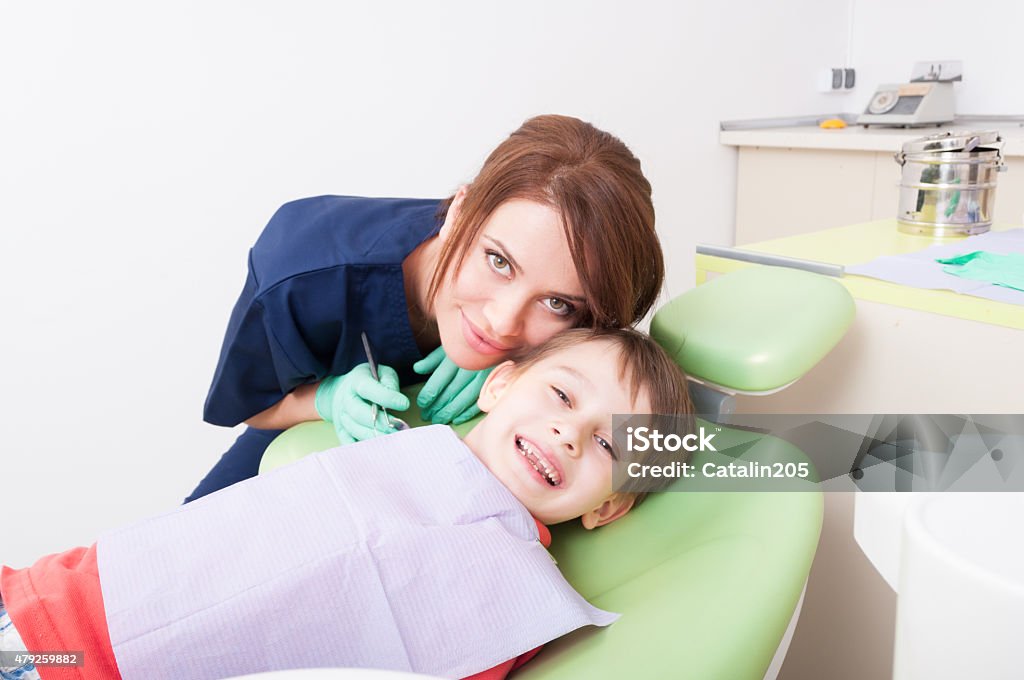 Happy child in dental office or at dentist Happy child in dental office or at dentist. Friendly and careful woman doctor 2015 Stock Photo