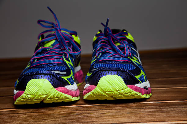 istock Pair of blue neon training shoes on a wooden flooR 479260244