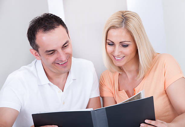 istock Happy couple looking at photo album 479260284
