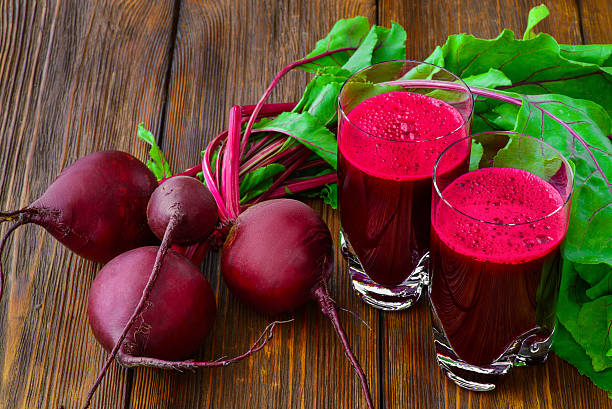istock Glass of fresh beetroot juice with bets on wooden table 479260440