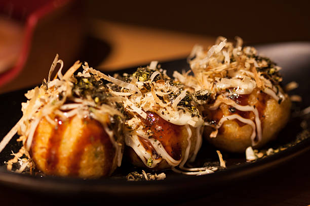 Japanese food, Takoyaki Takoyaki octopus balls - Japanese food, Takoyaki cooking takoyaki is a ball shaped japanese snack stock pictures, royalty-free photos & images