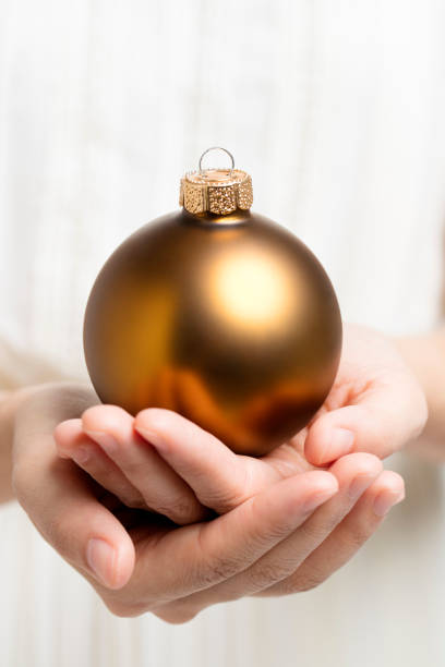 istock Christmas ball holding by hands 479267928