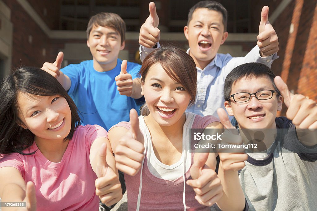 Group of happy students with thumbs up Group of asian happy students with thumbs up Achievement Stock Photo