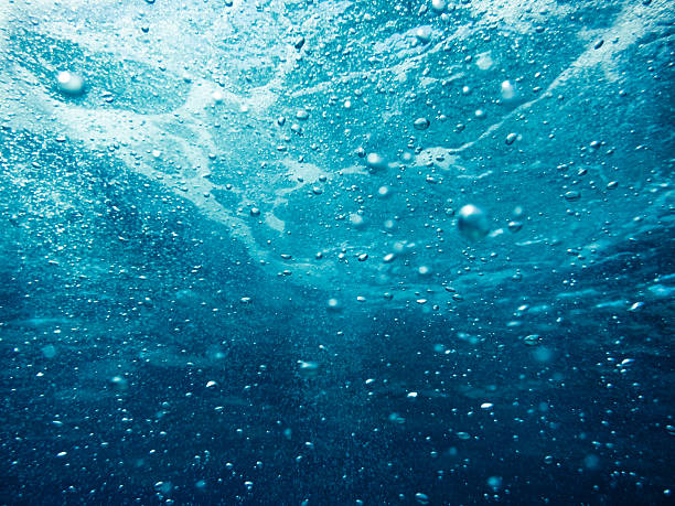 Underwater Splashes Background with air bubbles in the sea. purified water stock pictures, royalty-free photos & images